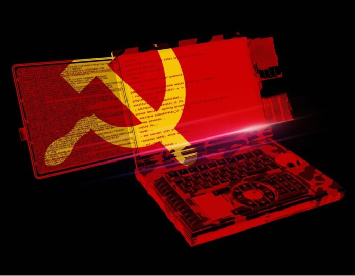 Red flag with yellow hammer-and-sickle emblem spreads over open laptop screen and keyboard